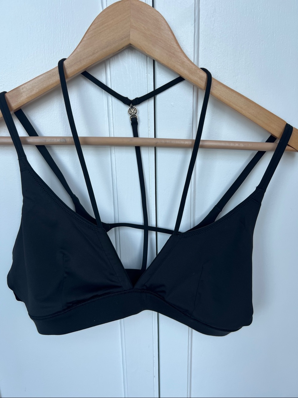 Lululemon black bathing suit top with gold emblem like new no pads
